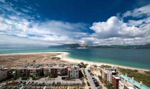 a view of a beach with buildings and the ocean at Troia - Paraíso a um passo de Lisboa in Troia
