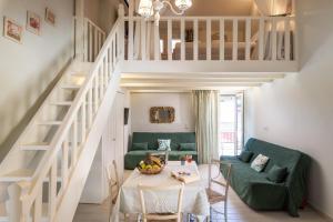 a living room with a green couch and a table at Τrilogy Studios in Syvota
