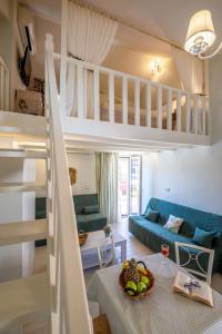 a room with a bunk bed and a living room at Τrilogy Studios in Syvota