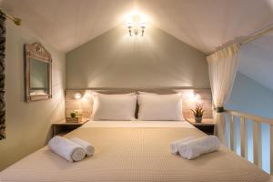 a bedroom with a bed with two pillows at Τrilogy Studios in Syvota