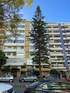 um parque de estacionamento com carros estacionados em frente a um edifício em Cosy Avenida Apartment em Faro