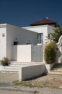 a white house with stairs in front of it at Ilios Vama Veche ADULT ONLY in Vama Veche
