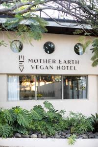 a building with a sign on the front of it at Mother Earth Vegan Hotel in Tamarindo