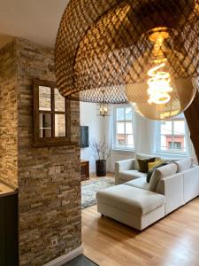 ein Wohnzimmer mit einem Sofa und einem großen Kronleuchter in der Unterkunft Grünberg House in Traben-Trarbach