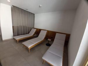 a hospital room with two beds and a window at Hotel Alpenfrieden in Kappl