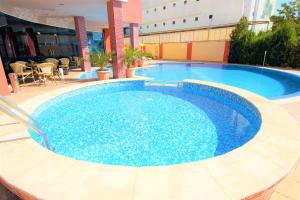 a large blue swimming pool on top of a building at Menada Apartments in Sunny Beach in Sunny Beach