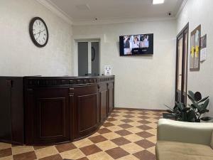 una sala de espera con un reloj en la pared en Хостел "Сириус" en Kislovodsk