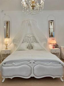 a bedroom with a white bed with a canopy at FSF Boutique Apartament in Timişoara