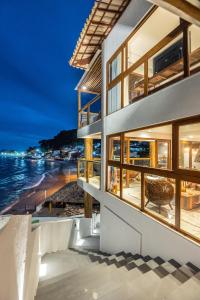 a house with a view of the beach at night at One Beach Boutique Hotel in Morro de São Paulo