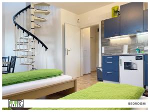 a kitchen with a spiral staircase in a room at ACO Living - A chilli Overnight in Klagenfurt