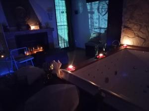 a person laying in a bath tub in a room with candles at Il Casaletto del Terminillo in Rieti
