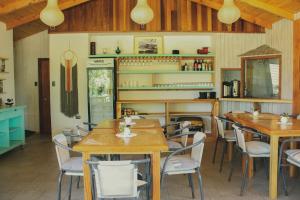 a dining room with wooden tables and chairs at Cabañas Parque Del Lago in Panguipulli