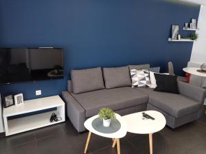 a living room with a couch and a tv at NY Central 2 in Patra
