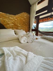Cama ou camas em um quarto em I'Lumiar Loft