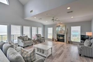 a living room with a couch and a table at Oceanfront Galveston Home - Walk to Beach! in Galveston