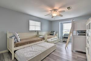 a bedroom with two bunk beds and a ceiling fan at Oceanfront Galveston Home - Walk to Beach! in Galveston