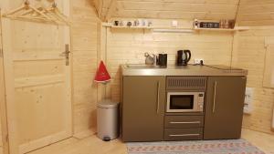 a small kitchen with a sink and a microwave at NatureZenKota in Mittlach