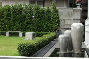 um grupo de estátuas de pedra num jardim em Baannueng at Aree 5 Hotel em Banguecoque