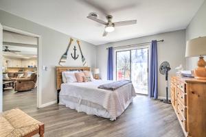 a bedroom with a bed and a living room at Updated Afton Cottage with Dock and Lake Access! in Afton