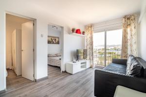 een woonkamer met een bank en een raam bij LOVELY APARTMENT Barca 2 in Barcelona