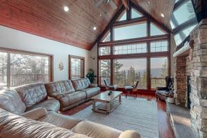 a living room with a couch and a large window at Glacier Peak Lodge in Yosemite West
