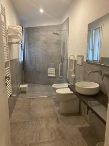 a bathroom with a toilet and a sink and a shower at A casa di Lella in Budrio