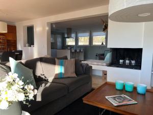 a living room with a couch and a table at Ferienwohnung Inselblick in Glücksburg