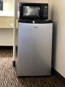 a microwave sitting on top of a refrigerator at Atlantic Inn in Pleasantville