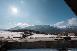 a view of a parking lot with snow covered mountains at Austrian Apartments in Bad Goisern