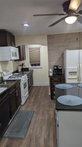 a large kitchen with white appliances and wooden floors at Beautiful and Cozy Homes in Cortland
