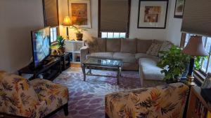 a living room with a couch and a tv at Beautiful and Cozy Homes in Cortland