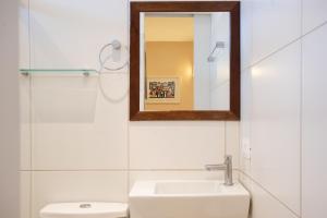 a bathroom with a sink and a mirror at Pousada Malibu in Fernando de Noronha