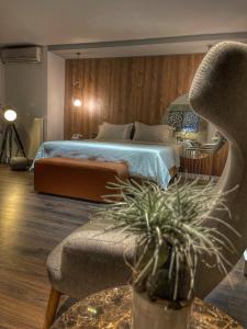 a bedroom with a bed and a couch and a chair at Trokadero Boutique Hotel in Itea