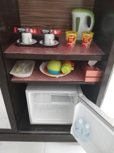 a toy kitchen with a shelf with food and drinks at Theme Park View Studio @ Gold Coast in Banting