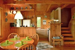 a kitchen with a table and chairs in a cabin at holiday home, Gowidlino in Gowidlino