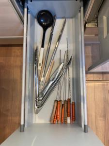 a refrigerator filled with utensils and other kitchen utensils at KAI Ichinomiya in Ichinomiya