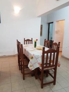 a dining room with a table and chairs with a tablecloth at La Viñita in Cafayate