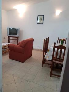 a living room with a couch and a table and a tv at La Viñita in Cafayate +18 photos