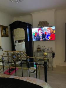 a living room with a flat screen tv on the wall at Olivia House in Porthcawl