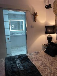 a bedroom with a bed and a window and a door at Olivia House in Porthcawl