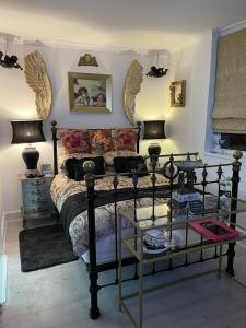 a bedroom with a bed with a glass table at Olivia House in Porthcawl