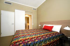 Ένα ή περισσότερα κρεβάτια σε δωμάτιο στο Laguna Serviced Apartments