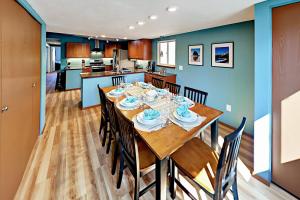 a dining room and kitchen with a table and chairs at Azure Waves in Seaside