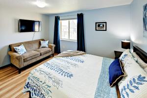 a bedroom with a bed and a couch at Azure Waves in Seaside