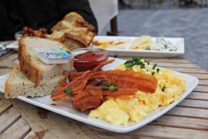 a plate of breakfast food on a wooden table at La Quinta Inn & Suites by Wyndham DC Metro Capital Beltway in Capitol Heights