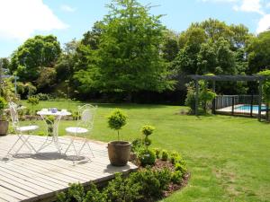 a wooden deck with a table and chairs in a yard at Room for Two in Richmond