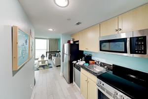 a kitchen with a sink and a refrigerator at Oceans One Resort Unit 403 in Myrtle Beach