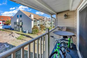 a bike on a balcony with a view of a house at Myrtle Beach Getaway in Myrtle Beach