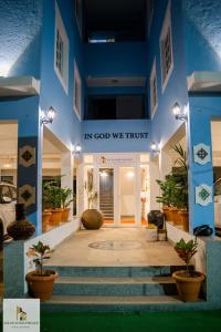a lobby with a sign that reads in god we trust at SOLAR MARIA PIEDADE in Panaji