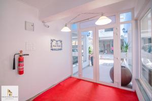 a red carpet in a room with a glass door at SOLAR MARIA PIEDADE in Panaji